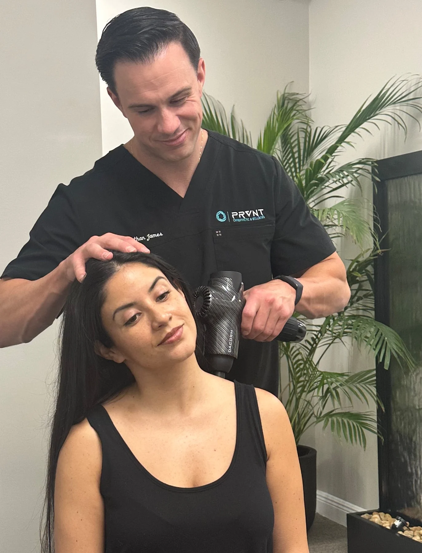 Recovery treatment using a percussion massage device at PRVNT.
